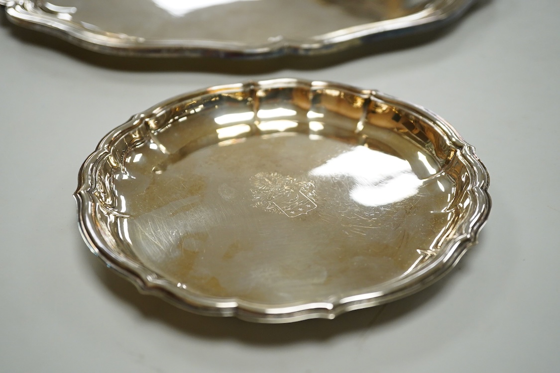 A German 800 standard white metal salver, diameter 35.9cm, together with a similar waiter, diameter 15.6cm, both with engraved armorial, 35oz.